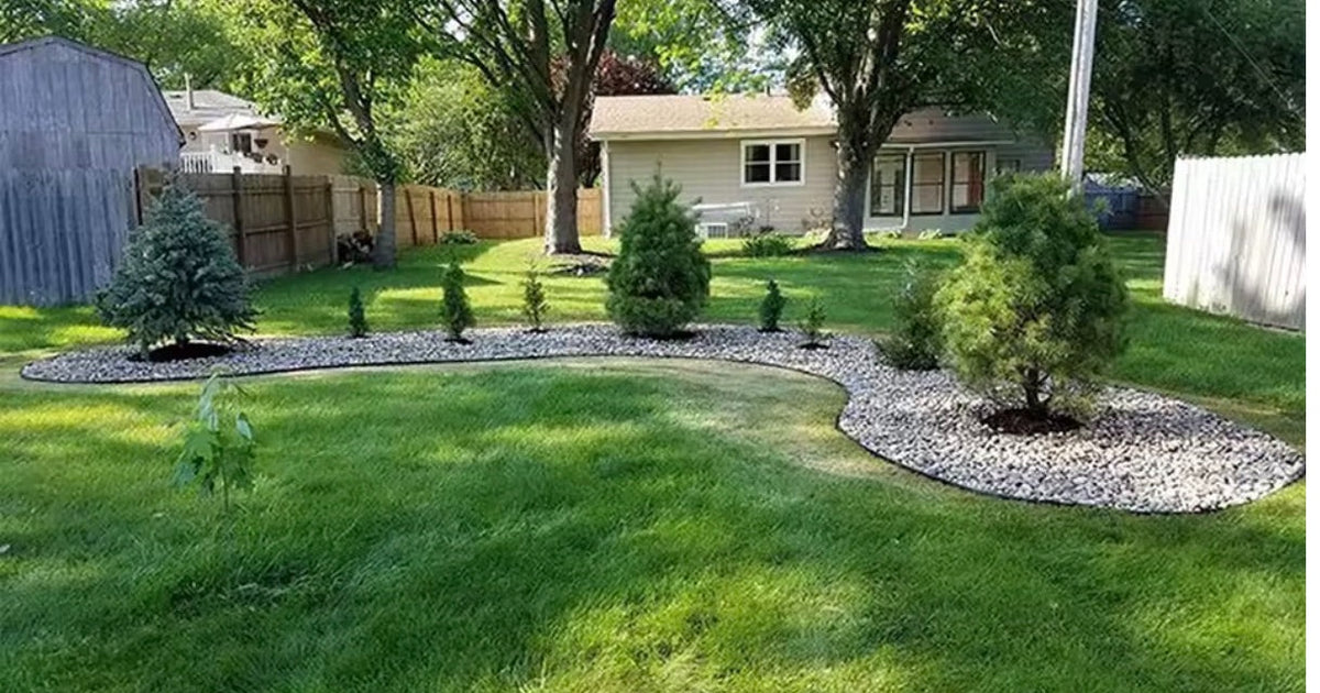 Wide view of a garden bed with a clean defined edge running along the lawn Image